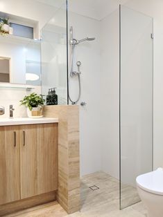 a bathroom with a sink, toilet and shower stall in it's own area