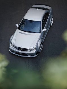 a white car is parked on the street