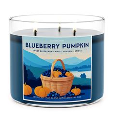 a blueberry pumpkin scented candle in a glass container with an orange basket on the front