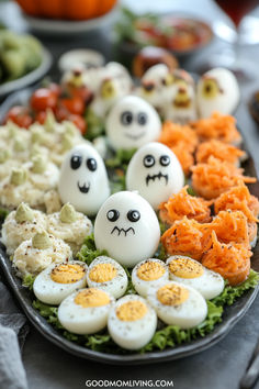 Halloween-themed appetizer platter featuring decorated hard-boiled eggs shaped like ghosts, creamy mashed potato ghosts with green accents, and shredded carrot treats, all arranged on a bed of lettuce. Perfect for festive gatherings and Halloween parties. Spooky Birthday Party, Halloween Birthday Party For Kids, Fun Halloween Appetizers, Kids Halloween Birthday Party, Halloween Birthdays, Mummy Crafts, Halloween First Birthday, Spooky Birthday