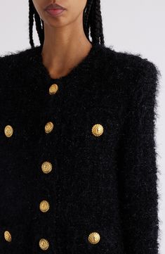 The iconic debossed buttons featuring the Double Chain Lion monogram line up on the snap placket and detail the faux pockets on this tweed jacket. 21" length (size 34FR) Front snap closure Jewel neck Long sleeves with decorative buttons Faux pockets with decorative buttons 36% polyamide, 32% viscose, 25% cotton, 7% polyester Dry clean Made in France Designer Clothing Luxury Tweed Jacket With Button Closure For Fall, Luxury Fall Tweed Jacket With Button Closure, Luxury Fall Tweed Jacket With Buttons, Luxury Long Sleeve Tweed Jacket With Buttons, Designer Tweed Jacket With Buttons For Fall, Luxury Tweed Outerwear With Button Closure, Designer Black Tweed Jacket, Designer Winter Tweed Jacket With Buttons, Luxury Black Outerwear With Gold Buttons