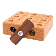 a wooden block with two holes in the middle and one hole at the top that has buttons on it