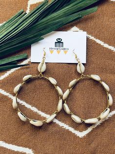 "Queen of Cowrie Hoops// Cowrie Hoop Earrings, African Jewelry, Statement Earrings, Cowrie Shell Earrings, Afrocentric, African Hoop Earrings \"Whoever is patient with a cowrie shell will one day have thousands of them\" -- Hausa proverb Get your hands on these 3 inch hoop earrings made of polished cowrie shells from the sea wrapped in brass wire. Be ready to receive tons of compliments as these hoops will be a show stopper! Earring is light and will not put pressure on earlobe.  Cowrie shells r Handmade Dangle Hoop Earrings For Vacation, Shell Dangle Hoop Earrings For Beach, Handmade Bohemian Hoop Earrings For The Beach, Bohemian Small Hoop Earrings For Beach, Summer Bohemian Circle Hoop Earrings, Handmade Cowrie Shell Earrings For Beach, Handmade Cowrie Shell Earrings For Gift, Handmade Shell Hoop Earrings For Beach, Handmade Cowrie Shell Earrings As Gift