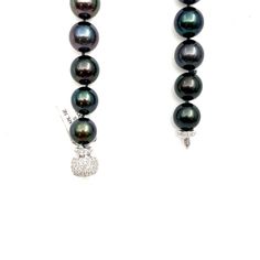 This beautiful black Tahitian pearl necklace ranges from 12 mm to 16.30 mm. The clasp has 114 round brilliant diamonds weighing 2.25 ct. The diamonds boast a color of E/F, are VS1 in clarity and are set in 18k white gold. A perfect piece for everyday wear! Luxury Black Pearl Necklace With Round Beads, Formal Black Tahitian Pearl Necklace, Luxury Black Single Strand Pearl Necklace, Luxury Black Tahitian Pearl Necklaces, Formal Black Tahitian Pearl Necklaces, Formal Black Tahitian Pearl Jewelry, Black Tahitian Pearl Jewelry With Round Beads, Black Tahitian Pearl Single Strand Jewelry, Black Tahitian Pearl Round Beads Jewelry