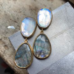 HANGING DOUBLE DROP EARRINGS, MOONSTONE, 16.5 CARAT, AND LABRADORITE, 15.76 CARAT SET IN 22K GOLD • DESIGNED AND HAND FORGED IN NEW YORK Please email info@elihalili.com or call the studio at 212-941-7979 for any inquiries Gold Faceted Moonstone Earrings, Labradorite Earrings, Oval Earring, Ruby Sapphire, Moonstone Earrings, Ancient Coins, 22k Gold, Hand Forged, The Studio