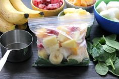 fruits and vegetables are in plastic bags on a table