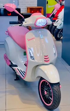 a pink and white scooter is on display