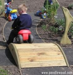 a kid is sitting on a bench made out of wooden planks and has the caption that reads, i need a bridge bigger than this to go over our pond in the backyard @ cute ride