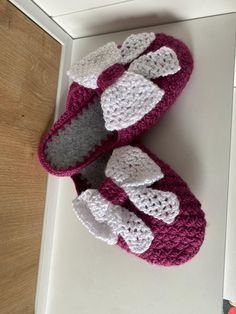 two crocheted slippers sitting on top of a table