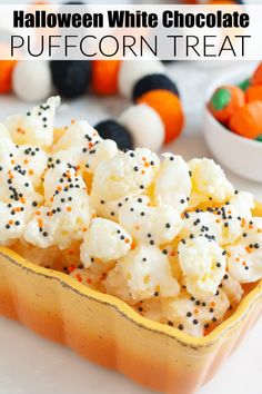 halloween white chocolate popcorn treat with sprinkles in a yellow bowl on a table