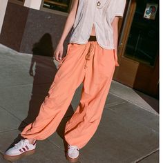 Urban Outfitters Nylon Jogger Pant. New With Tags, Orange, Size Small, Medium And Xl. Lightweight Nylon Jogger Pant From Urban Outfitters. Pull-On Design Offers A Slouchy Fit With Elastic Banding At The Tie-Waist And Cuffs. Topped With Utility Pockets At The Leg And Slip Pockets At The Hips. Content + Care - 100% Nylon - Machine Wash Size + Fit - Model In Orange Is 5’10” And Wearing Size Small - Rise: 14.25” - Inseam: 26” - Leg Opening: 14” Sporty Parachute Pants For Summer Outdoor, Sporty Summer Parachute Pants For Outdoor, Solid Parachute Pants For Summer Outdoor, Summer Outdoor Solid Color Parachute Pants, Summer Outdoor Relaxed Fit Parachute Pants, Summer Streetwear Relaxed Fit Parachute Pants, Spring Ankle-length Parachute Pants With Drawstring, Spring Outdoor Parachute Pants, Spring Outdoor Solid Color Parachute Pants