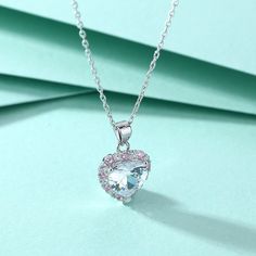 Indulge in the beauty and elegance of the 2.0 Ct Heart Shaped Moissanite Necklace from Evani Naomi Jewelry. Made from 92.5% pure silver + 7.5% hypoallergenic metals, this necklace is dipped 5x in 18k white gold for added shine and durability. The heart cut moissanite stone is equally beautiful and shining at about 1% of the cost of a mined diamond. Ethically sourced and finely handcrafted, this necklace is the perfect combination of high quality and affordability. MATERIALSMetal Type: Silver 925 Silver Heart Necklace With Gemstone For Wedding, Mother's Day Silver Crystal Heart Necklace, Silver Crystal Necklace With Heart Cut, Silver Heart Cut Crystal Necklace, Silver Crystal Heart Cut Necklace, Silver Crystal Heart Necklace, Silver Moissanite Heart Pendant Necklace, Silver Solitaire Heart Cut Necklace Gift, Silver Heart Cut Solitaire Necklace For Anniversary