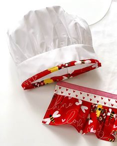 two pieces of red and white fabric with hearts on them next to a chef's hat