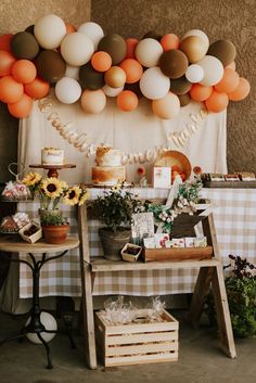 a table topped with lots of cake and balloons