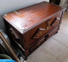 an old wooden chest is sitting on the floor