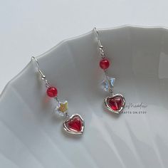 "Handmade Beaded Earrings ✿ Made with glass beads, freshwater pearls, and metal accents ✿ Silver, iridescent clear, and cherry red ✿ The earrings are 2.5\" long Fish Hook Options ✿ The Titanium fish hook is hypoallergenic and ideal for sensitive skin ✿ The regular fish hook is made of nickel free metal, it is not hypoallergenic" Red Dangle Earrings, Handmade Bead Earrings, Candied Cherries, Red Beaded Earrings, Handmade Earings, Handmade Beaded Earrings, Earrings Beads, Cherry Earrings, Handmade Earrings Beaded