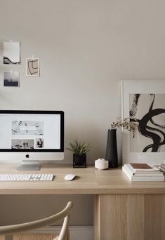 a computer monitor sitting on top of a wooden desk next to a keyboard and mouse