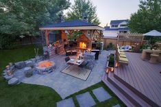 an outdoor patio with fire pit and seating area