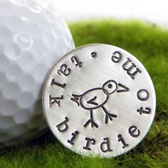 a golf ball marker with the words gift ideas for golf fanaticss