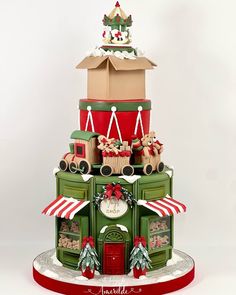 a three tiered christmas cake with santa's sleigh on top