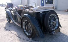 an old car parked in front of a building