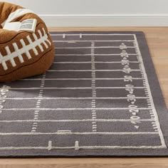 a football themed dog bed is on the floor