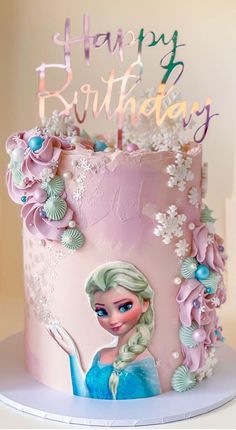 a pink birthday cake decorated with an image of a frozen princess