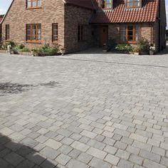 a large brick house sitting on the side of a road