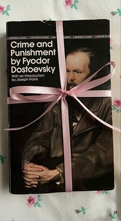 a book with a pink ribbon tied around it