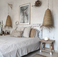 a bedroom with two hanging baskets on the wall and a bed in front of it