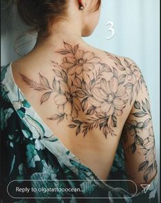 the back of a woman's neck with flowers on it