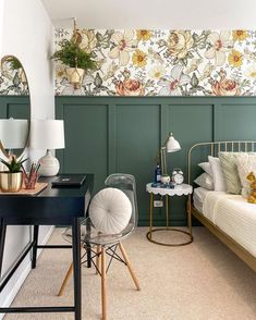 a bedroom with green walls and floral wallpaper