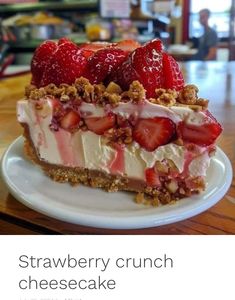 a piece of strawberry crunch cheesecake on a white plate with the words strawberries