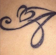 a close up of a tattoo on the back of a woman's shoulder