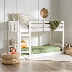 a white bunk bed sitting on top of a hard wood floor