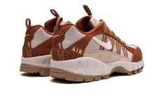 The Nike Air Humara "Future Movement - Dark Russet" is an earth tone colorway of the classic performance outdoors shoe.  Debuted in 1997, the Air Humara was introduced under Nike’s ACG (All Conditions Gear) collection before it was brought back as a lifestyle shoe in more recent years.  Here, the upper features a Peach Cream ripstop-like base with Dark Russet nubuck overlays.  Select panels on the toe and heel also feature a debossed geometric pattern.  The burnt orange hue is also found on the Nike Air Humara, Peach Cream, Nike Basketball Shoes, Peaches Cream, Stadium Goods, Nike Basketball, Burnt Orange, Basketball Shoes, Nike Shoes