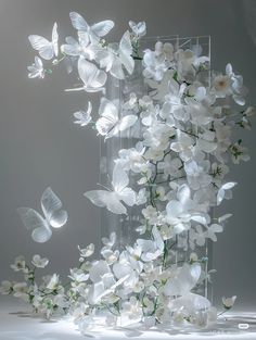 white flowers and butterflies floating in the air