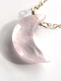 Pretty in pink. This rose quartz moon crystal pendant necklace is the perfect healing piece to add to your jewelry collection. Exuding dusty soft shades of pink, rose quartz helps soothe your heart and emit love to those all around you. Embrace the delightful beauty and tranquil benefits of this gentle and graceful creation.   Pink Rose Quartz Crystal Pendant Necklace•Beautifully faceted and carved to a moon shape •Soft and feminine style•Loving calm energy — speaks directly to your heart chakcr Pink Quartz Jewelry As A Gift, Pink Quartz Jewelry As Gift, Pink Quartz Jewelry Gift, Pink Quartz Jewelry For Gift, Pink Quartz Jewelry For Gifts, Pink Quartz Jewelry For Healing, Delicate Pink Rose Quartz Crystal Necklace, Delicate Pink Rose Quartz Necklace, Pink Rose Quartz Round Pendant Jewelry