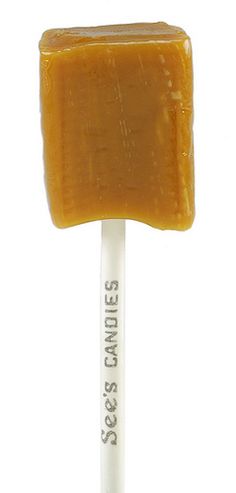 an orange lollypop is on a white stick with the words soaps candies