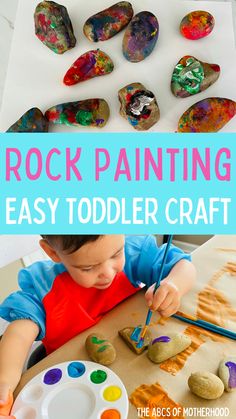 a young boy painting rocks with the words rock painting easy toddler craft on it