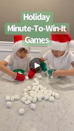 two children sitting at a table with marshmallows in front of them