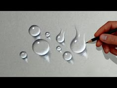 someone is drawing water drops with a pencil