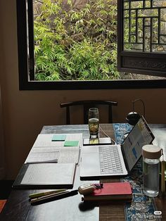 a laptop computer sitting on top of a wooden table