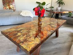 a vase with flowers sitting on top of a table in a living room next to couches