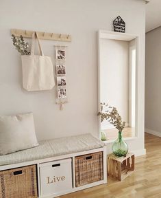 there is a bench with baskets on it in the living room next to a door