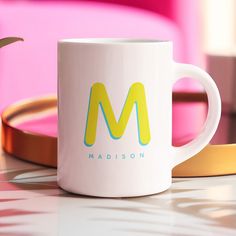 a white coffee mug sitting on top of a table