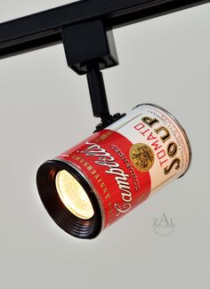 a light that is on the ceiling with a can in it's hand and some lights