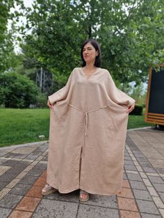 Experience unmatched comfort and stylish design with the Linen Kimono Oversized Dress - Morkva Dune. Crafted from 100% organic linen, this dress is perfect for any body type, thanks to its uniquely wide cut. The design of this dress is inspired by traditional Japanese kimonos and the iconic characters from the film "Dune", traveling across vast deserts. This combination gives the dress a distinctive character, making it a true masterpiece in the world of fashion. The Morkva Dune Kimono Dress will not only amaze everyone with its extraordinary appearance but also provide you with incredible comfort. The natural linen and loose fit create a lightweight, breathable garment, ideal for warm weather. Discover the perfect blend of style and comfort with the Morkva Dune Dress and become the center Spring Linen V-neck Kaftan, Linen Maxi Dresses For Loungewear, Casual Linen V-neck Kaftan, Oversized Linen Maxi Dress, Oversized Linen V-neck Tunic, Oversized Linen V-neck Dress, Bohemian Oversized Tunic Linen Dress, Oversized Bohemian Linen Tunic Dress, Relaxed Fit Linen Maxi Dress Tunic