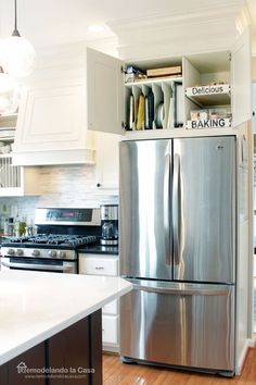 a stainless steel refrigerator in a white kitchen