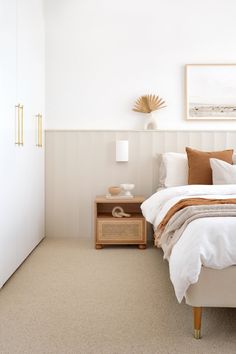 a bedroom with white walls and beige carpet